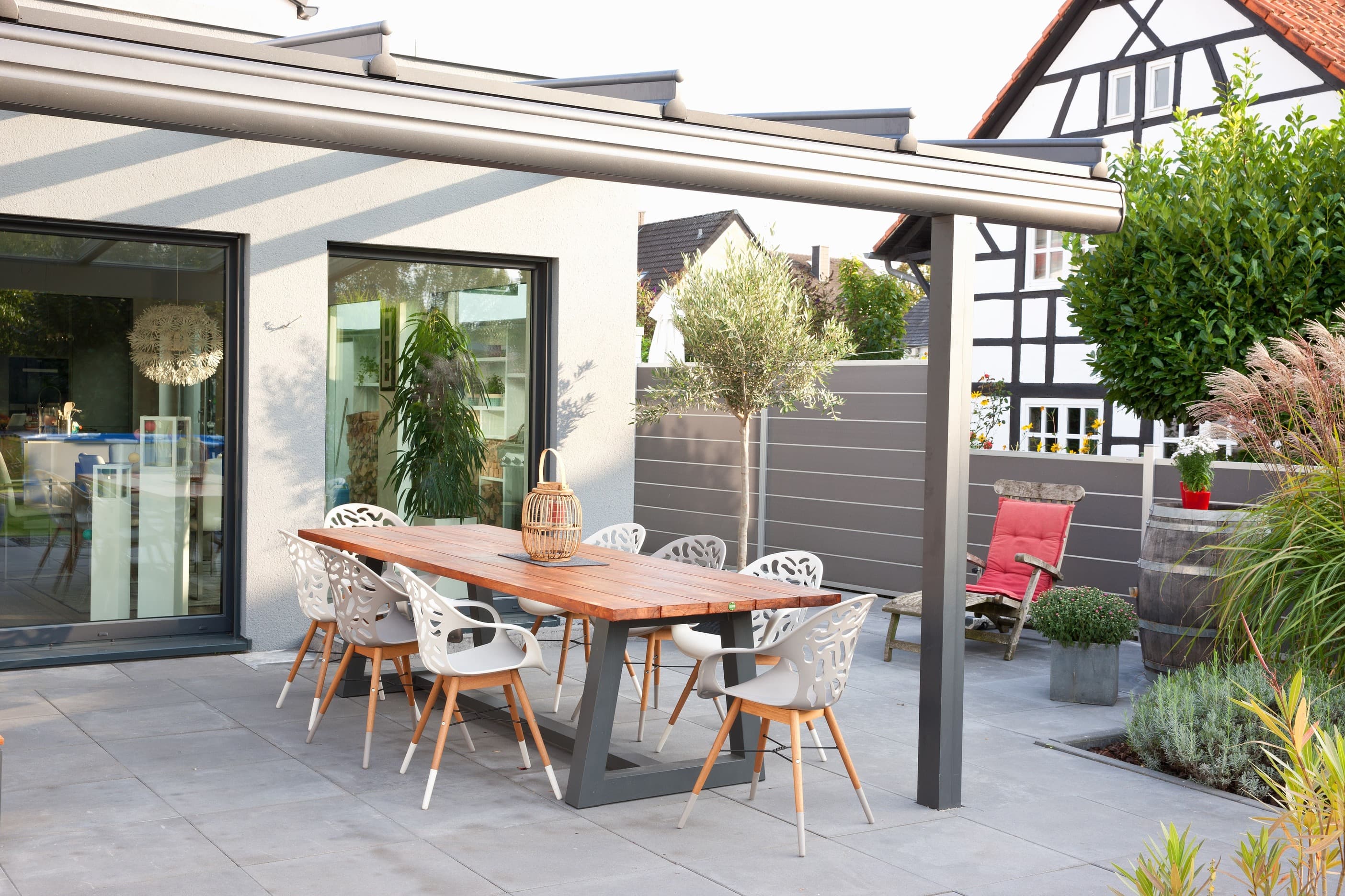 Terrasse mit Pergola eines modernen geförderten Wohnhauses — realisiertes Referenzprojekt